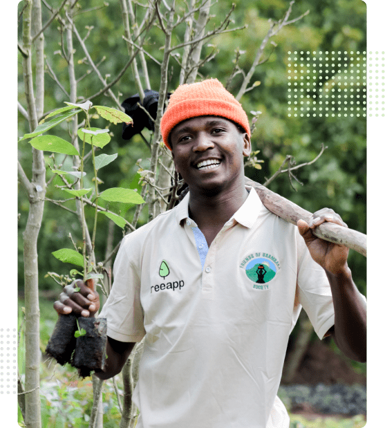 Young man with a tree sapling wearing Treeapp T-Shirt