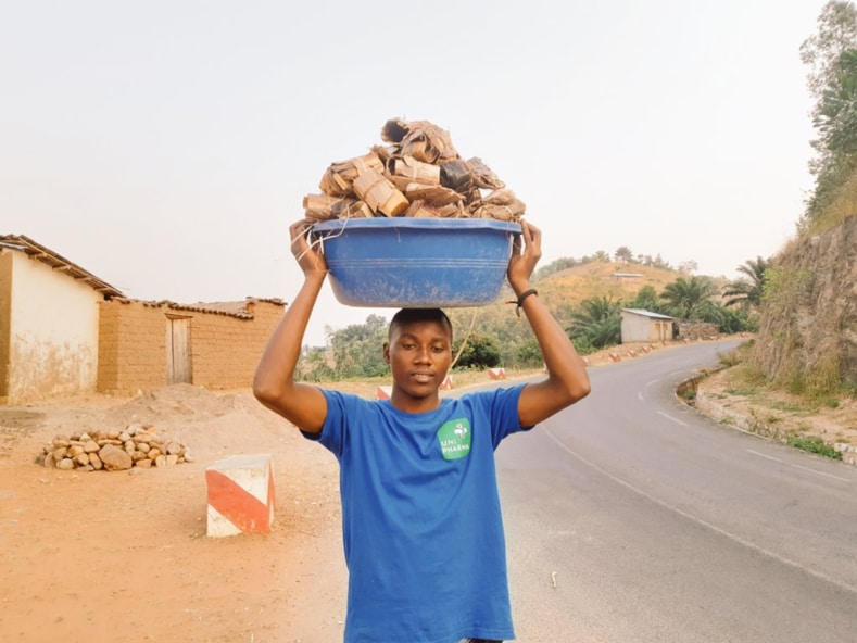Founder of Greening Burundi Emmanuel Niyoyabikoze carrying biodegradable seedling bags