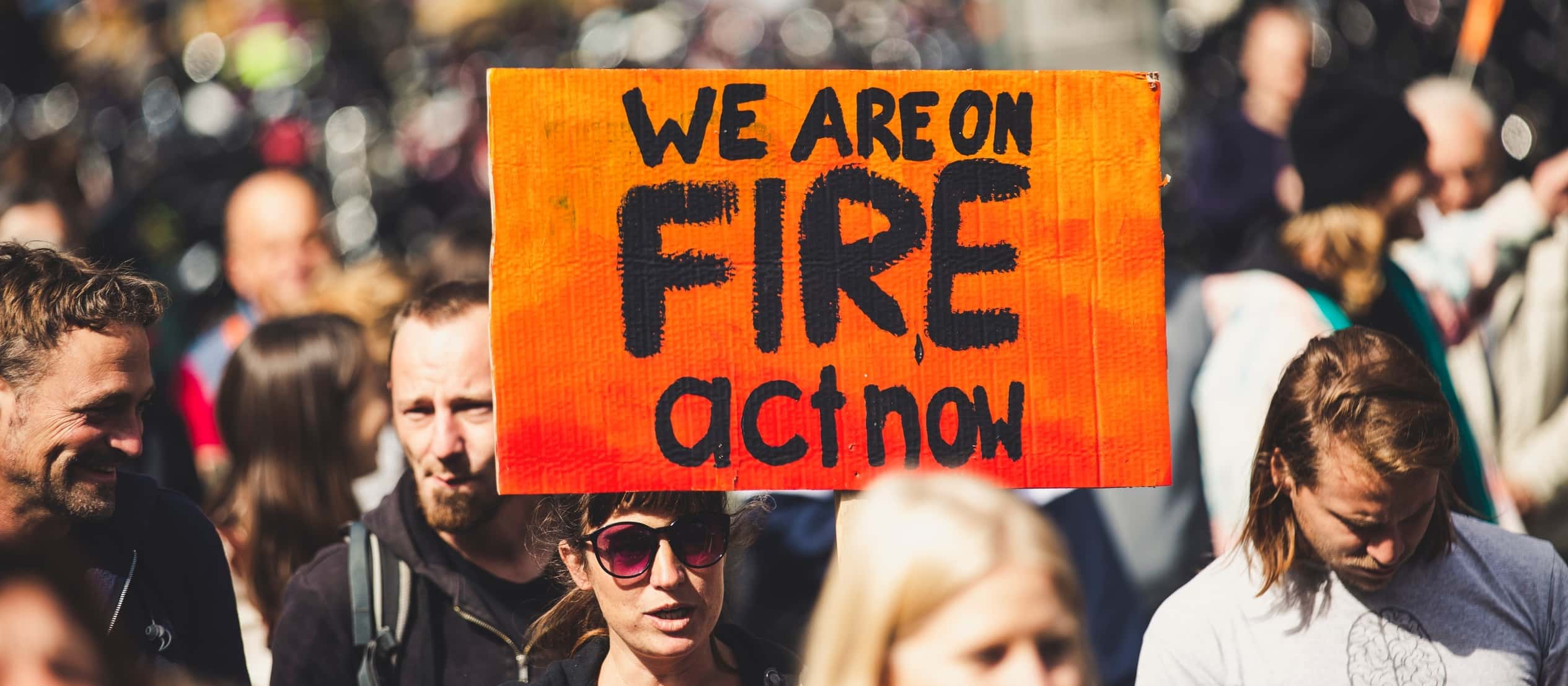 “We are on fire act now” banner (Source: Unsplash)
